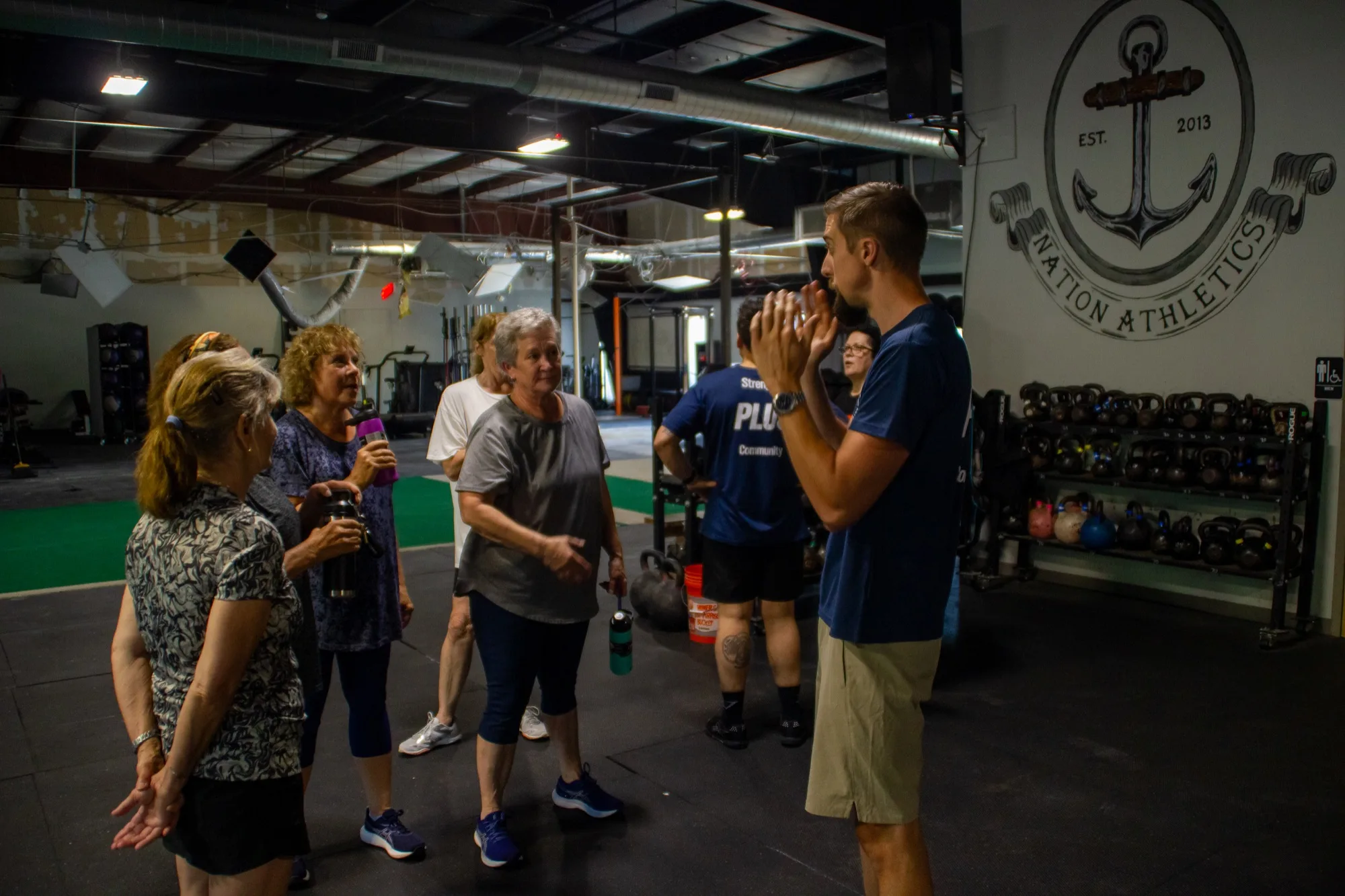 Coach Rich Krueger talks with PLUS class members at Top Form Physical Therapy in Branford, Connecticut