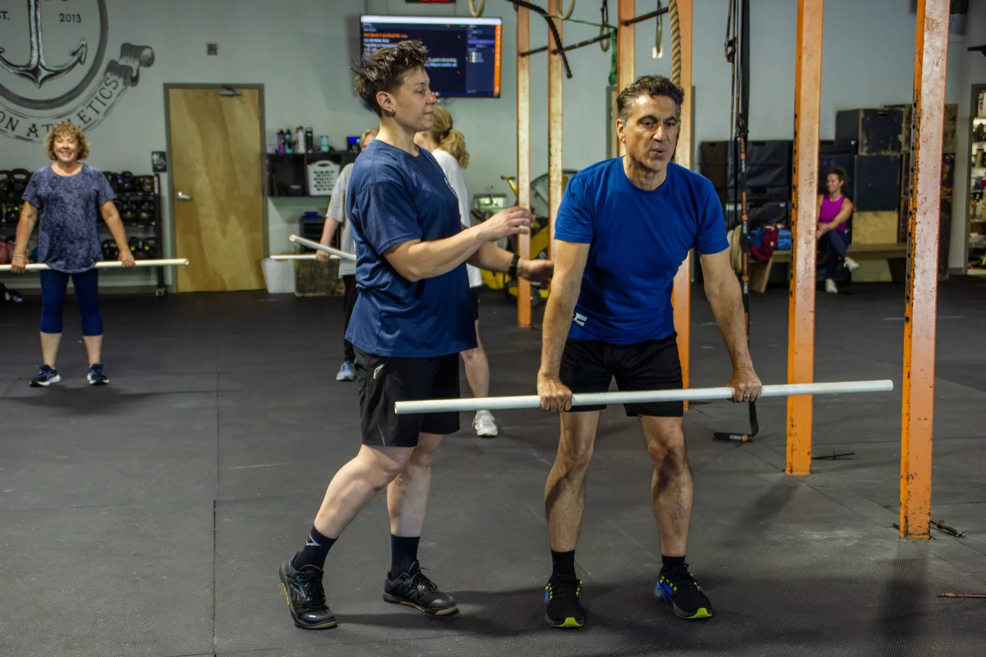 A Top Form coach gives hands-on form coaching to a client in Branford, CT