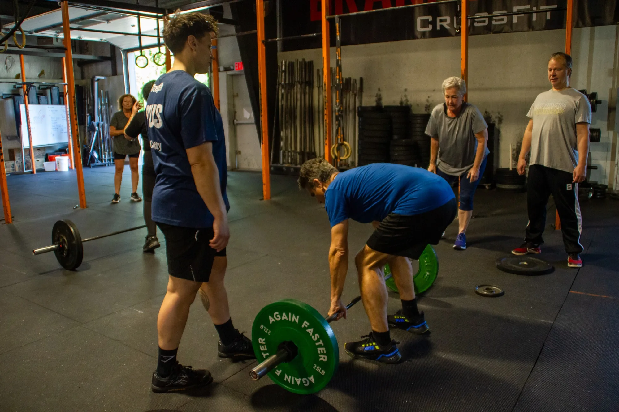 Coach Jen Ciardulli leads a PLUS class through barbell deadlifts at Top Form Physical Therapy in Branford, Connecticut